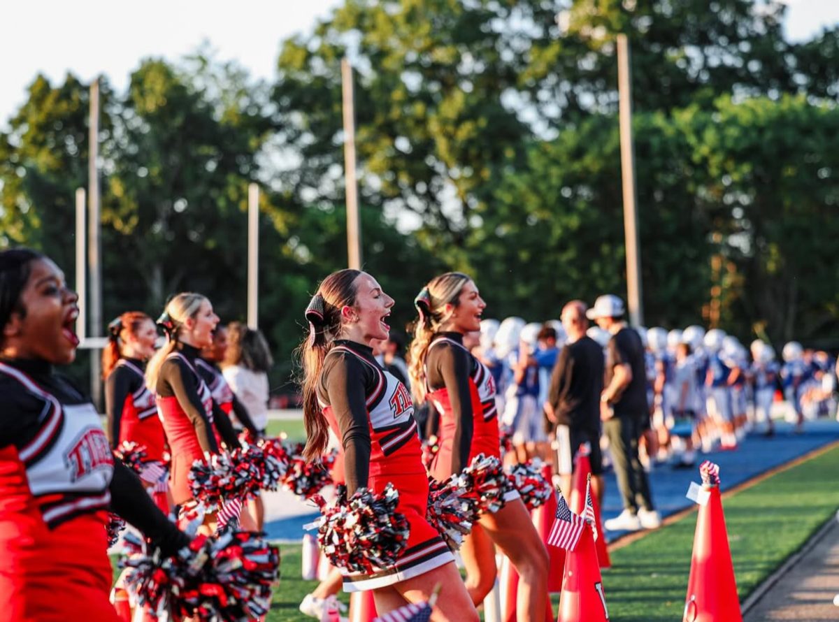 Cheering on the Tigers during their first game against the Trinity Hillers